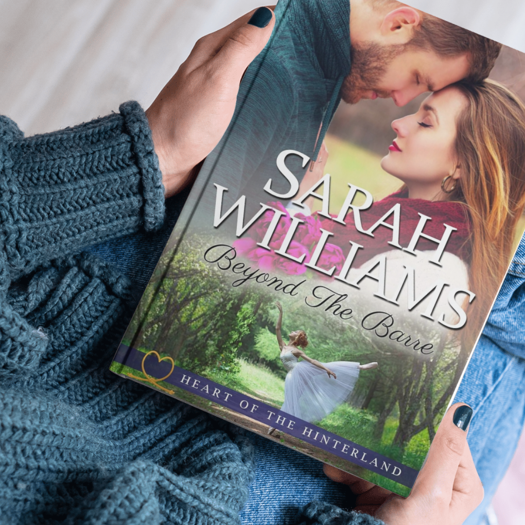 Book titled 'Beyond The Barre' by Sarah Williams held by a person wearing a blue sweater.