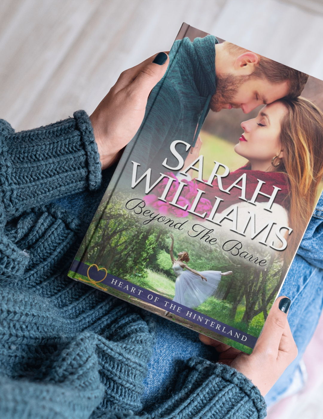 Book titled 'Beyond The Barre' by Sarah Williams held by a person wearing a blue sweater.