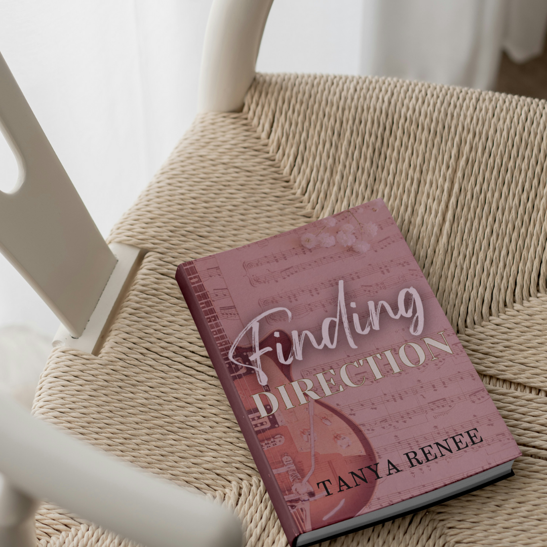Book titled 'Finding Direction' by Tanya Renee on a woven chair