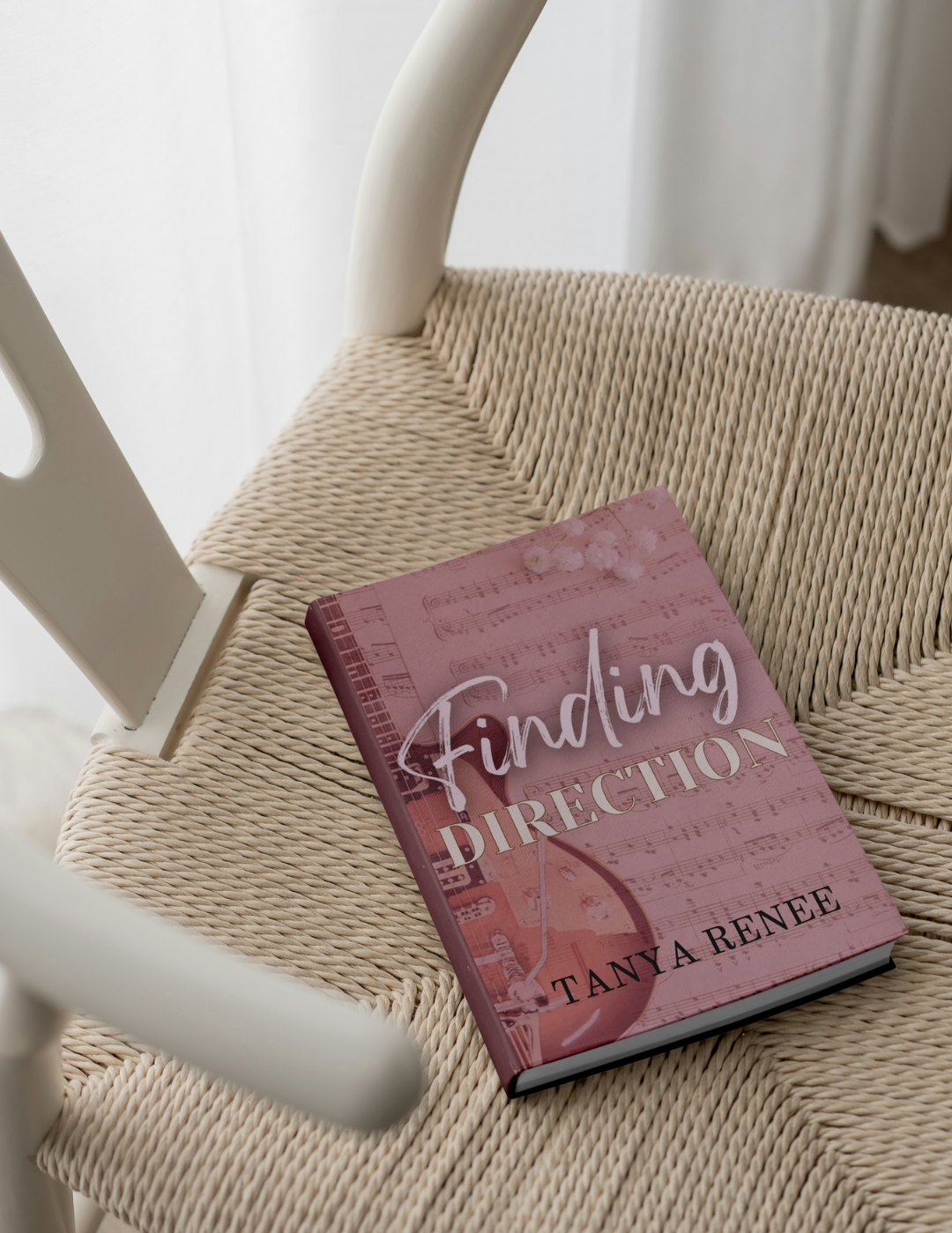 Book titled 'Finding Direction' by Tanya Renee on a woven chair