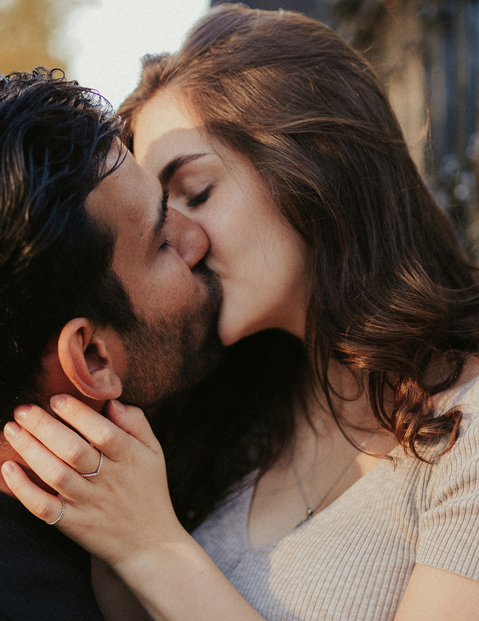 Couple sharing a kiss with a warm, intimate atmosphere.