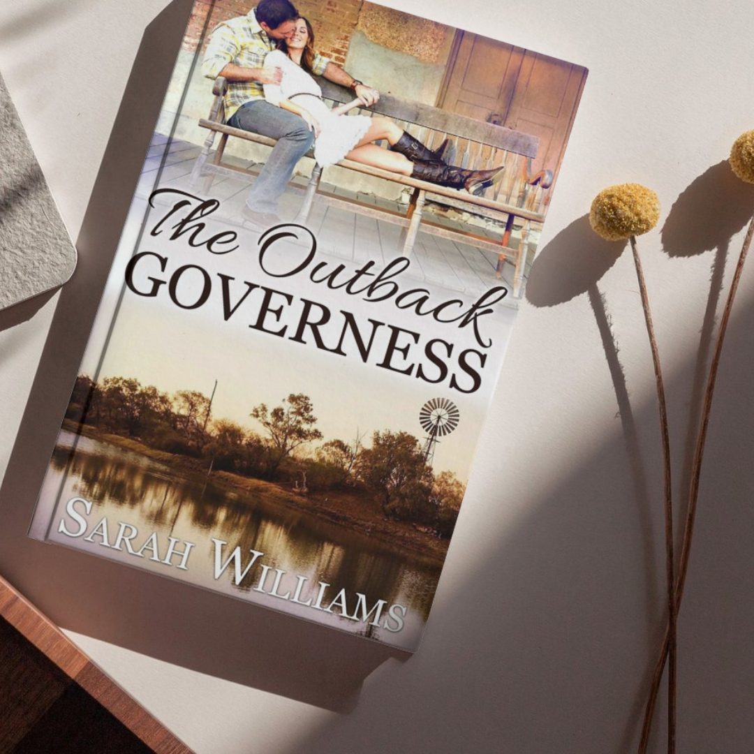 Book titled 'The Outback Governess' by Sarah Williams on a surface with a scenic cover.