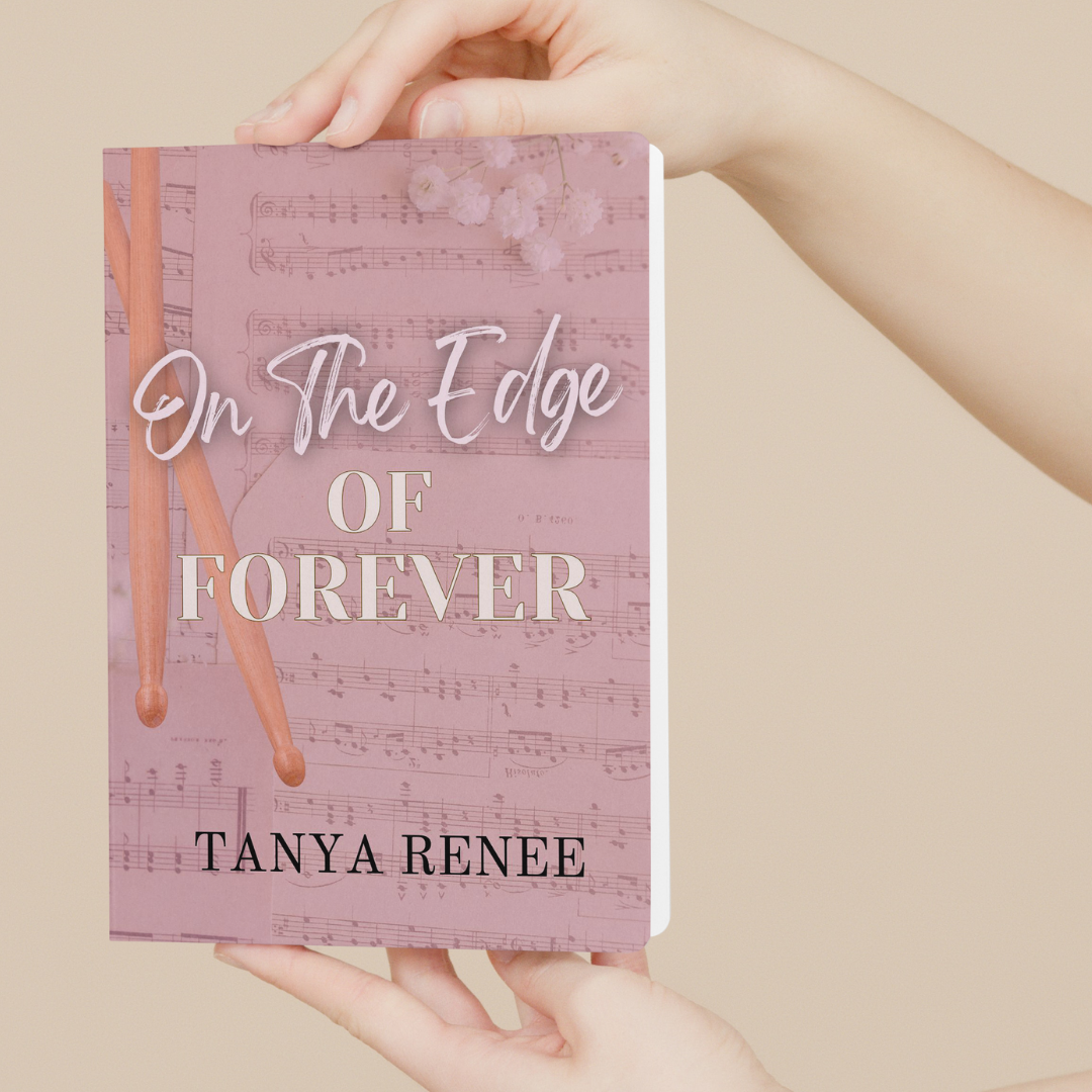 Book titled 'On The Edge Of Forever' by Tanya Renee held in hands against a beige background
