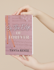 Book titled 'On The Edge Of Forever' by Tanya Renee held in hands against a beige background