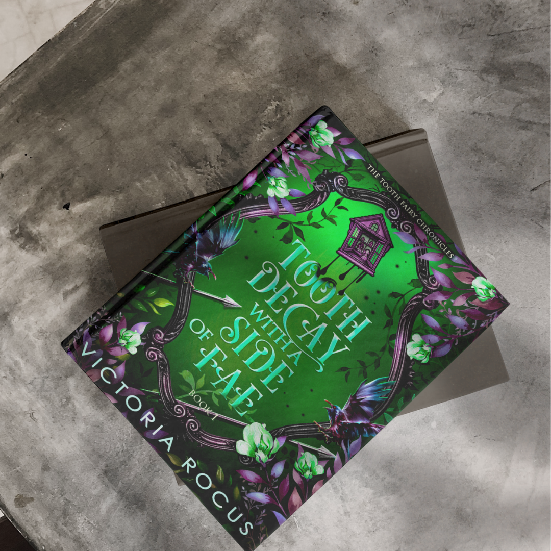 Book titled 'Tooth Decau with a Side of Fae' by Victoria Rogus on a textured surface