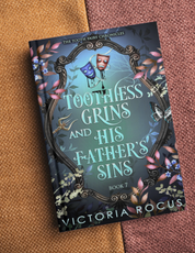 Book titled 'Toothless Grins and His Father's Sins' by Victoria Rocus on a textured surface