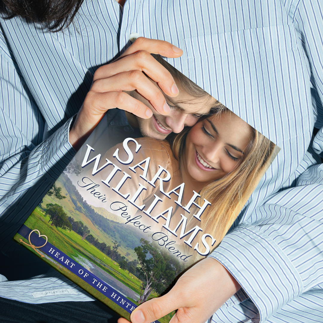 Person holding a book titled 'Their Perfect Blend' by Sarah Williams