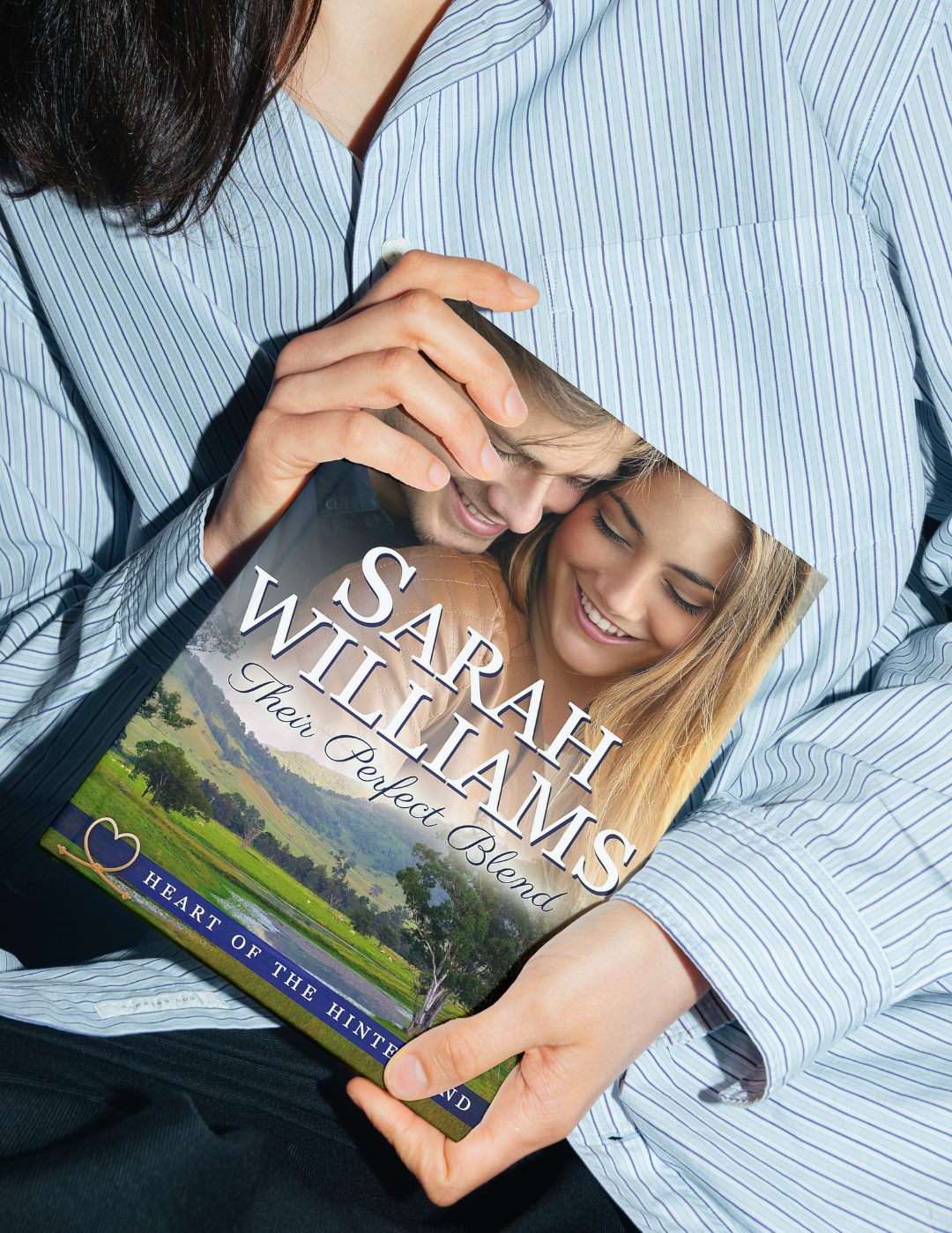 Person holding a book titled 'Their Perfect Blend' by Sarah Williams