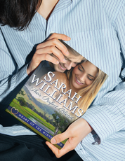 Person holding a book titled 'Their Perfect Blend' by Sarah Williams