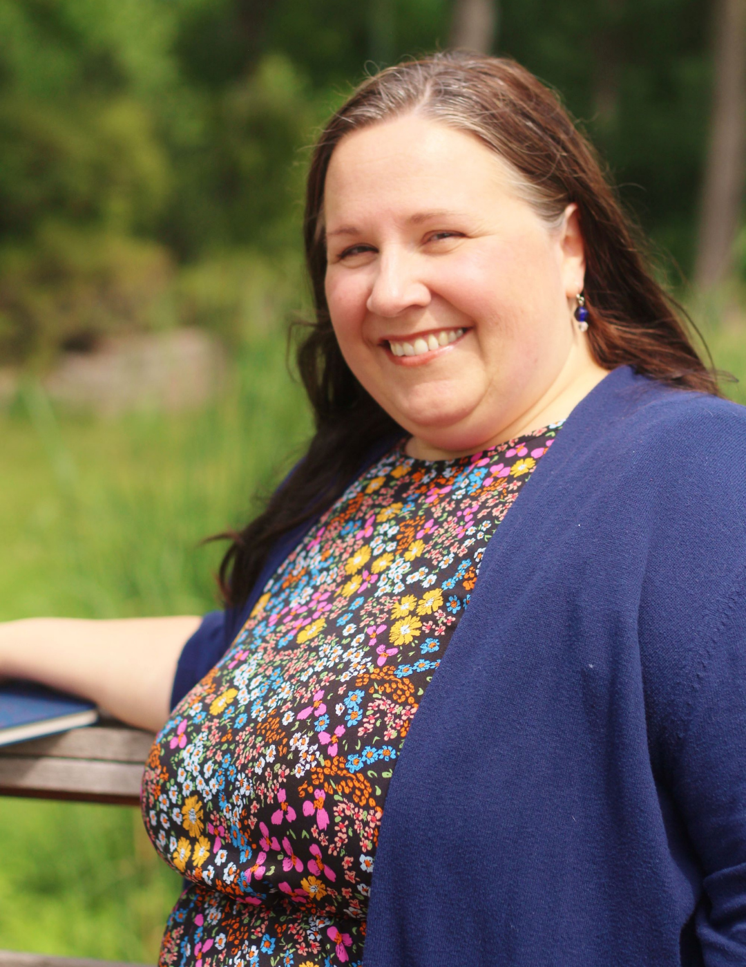 Author Tanya Renee smiling outdoors with a blurred natural background