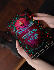 Book titled 'Toothaches and Wedding Cakes' by Victoria Rocus held by a person.