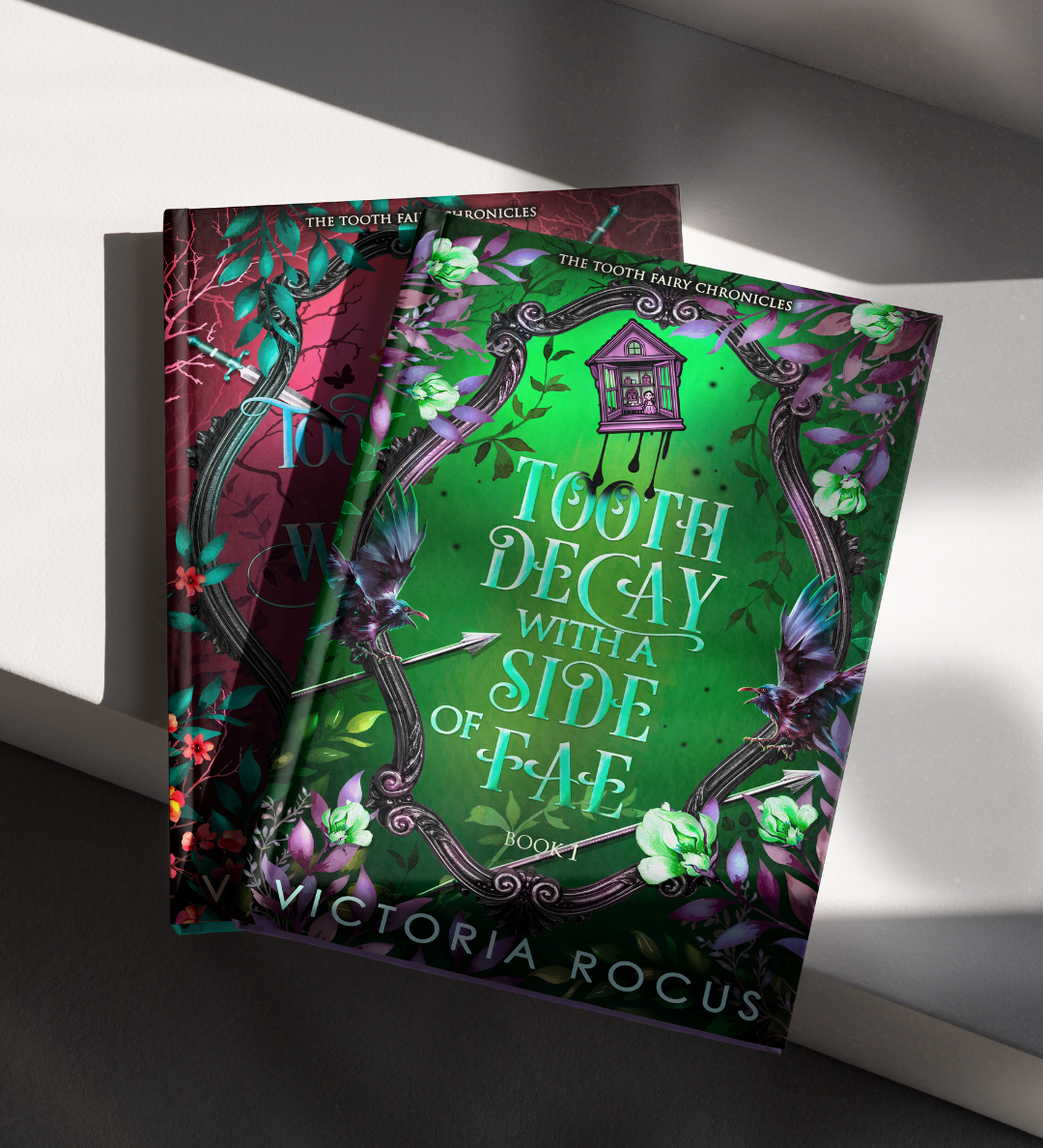 Two books titled 'Tooth Decay with a Side of Fae' and 'The Tooth Fairy Chronicles' by Victoria Rocus on a white surface.