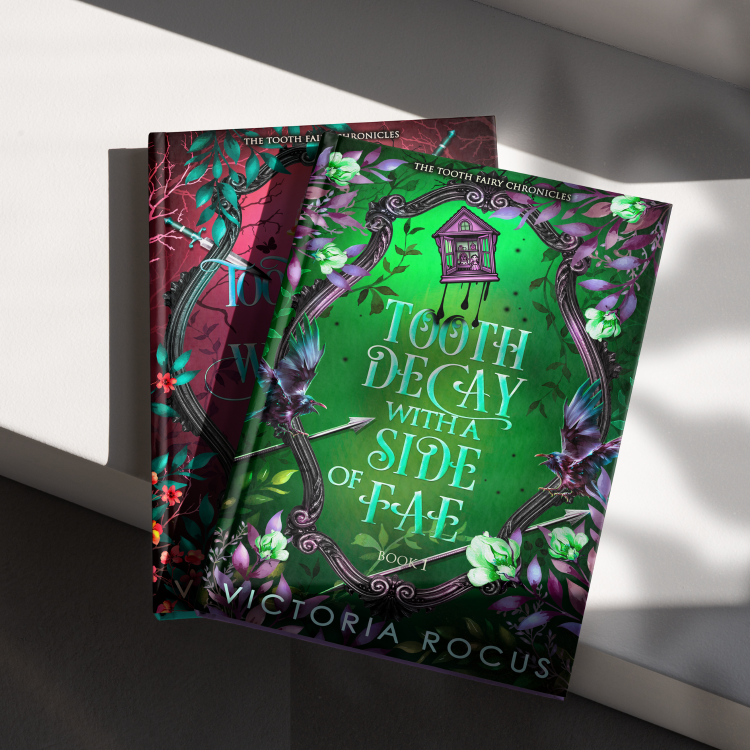 Book titled 'Tooth Decay with a Side of Fae' by Victoria Rocus on a white surface.